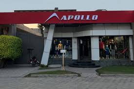 Exterior view of the Apollo Sports Shop, featuring a red signboard and a modern storefront with mannequins displayed in the windows.