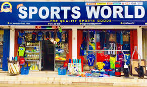 A well-organized cricket equipment shop displaying a variety of cricket bats, gloves, and protective gear arranged neatly on shelves.