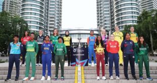 Group photo of ICC Women’s U19 T20 World Cup 2025 team captains in front of the Petronas Towers, standing around the tournament trophy in vibrant jerseys.