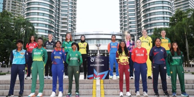 Group photo of ICC Women’s U19 T20 World Cup 2025 team captains in front of the Petronas Towers, standing around the tournament trophy in vibrant jerseys.