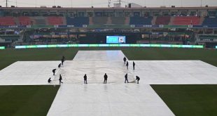 Ground staff covering the cricket field with protective sheets due to rain at Rawalpindi Stadium during the ICC Champions Trophy 2025.